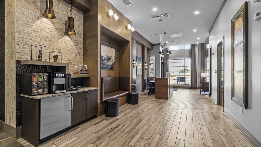 the lobby of a hotel with a reception desk and a coffee machine