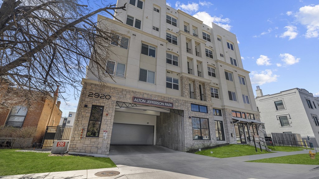 an apartment building with a large garage door in front of it