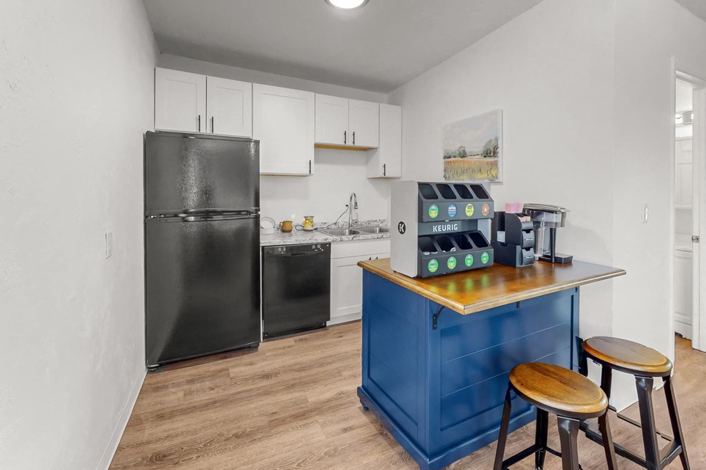 Creekside Apartments a kitchen with a counter top and a refrigerator