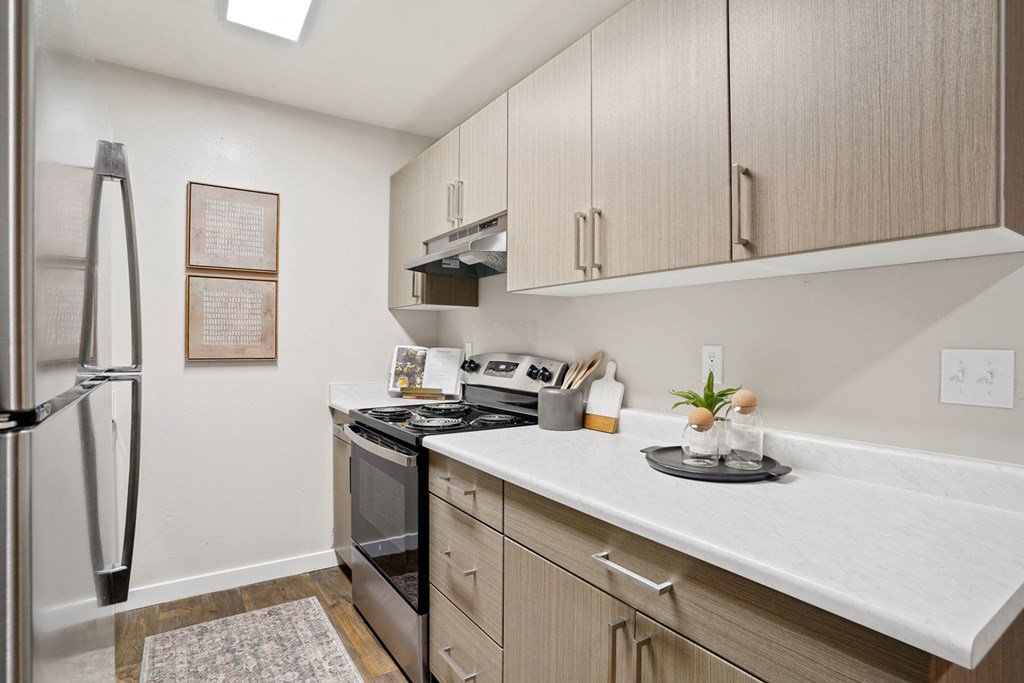 The Grove Apartments kitchen with electric range and stainless steel fridge