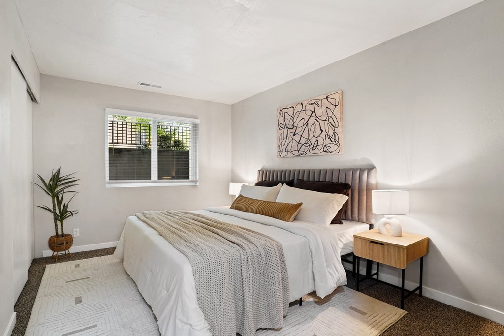 The Grove Apartments bedroom with large bed and night stands