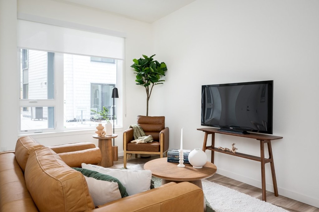 The Wes Gresham Oregon Apartments living area with tv, chair and couch