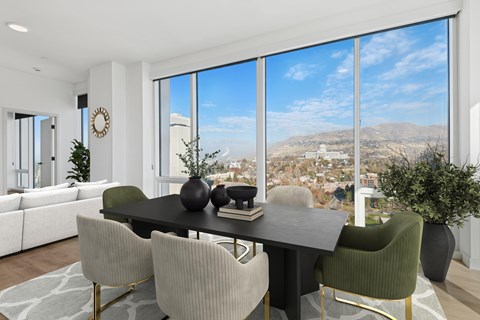 A modern dining room with a large table and chairs.