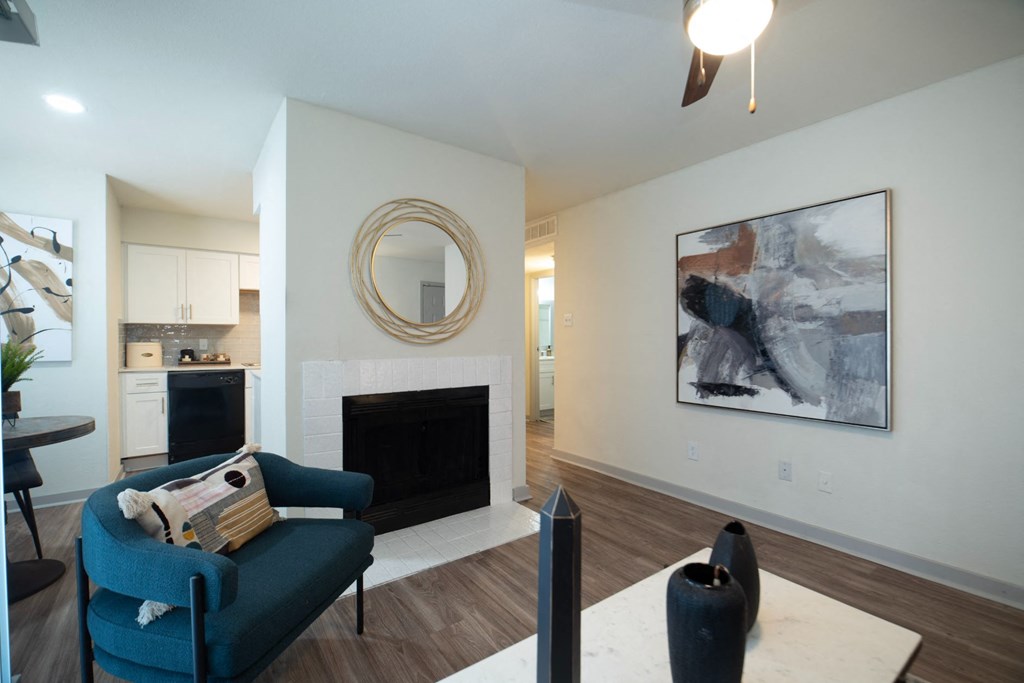 a living room with a fireplace and a blue chair