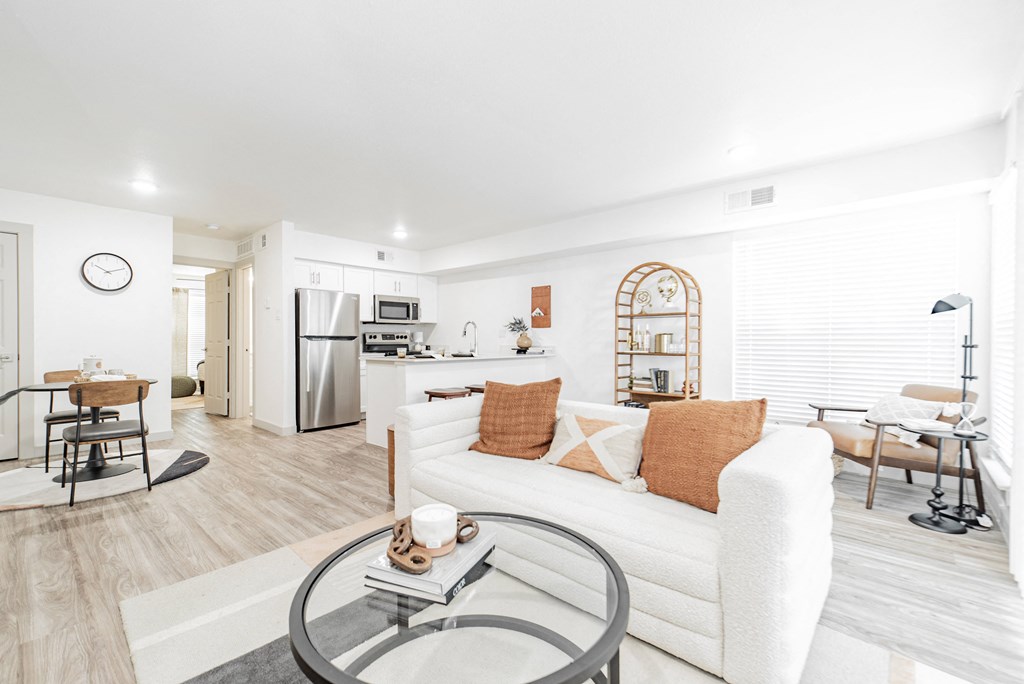 a living room with a couch and a glass table