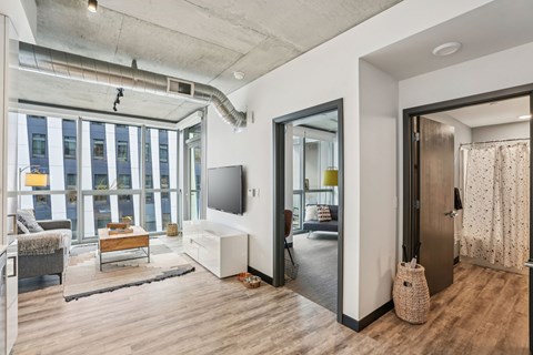 A modern living room with a large window and a flat screen TV.