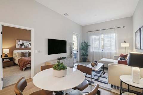 A living room with a white table and chairs.