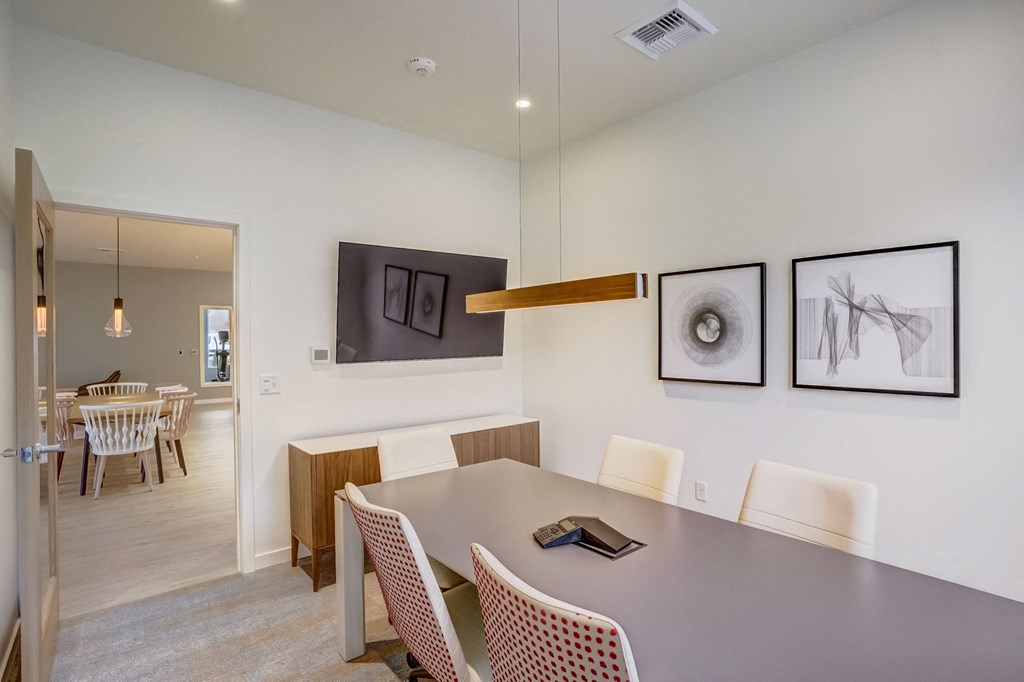 a dining room with a table and chairs