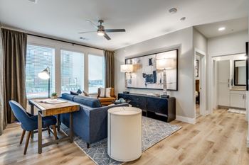 A modern living room with a dining table and chairs.