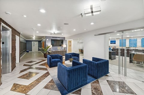 Lobby with seating and television at  735 St. Clair Apartments in Portland, Oregon