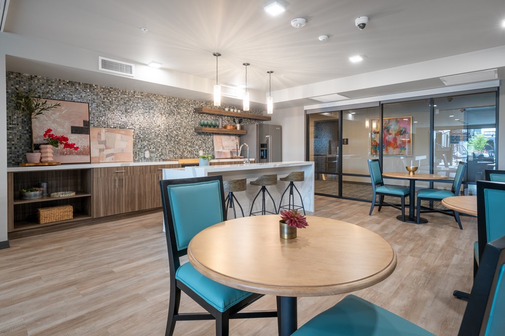 A restaurant with a wooden table and blue chairs.