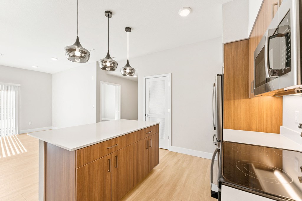 a kitchen with wooden cabinets and a white counter top