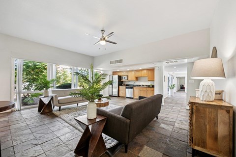 A living room with a brown couch and a wooden coffee table.