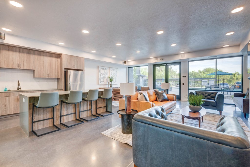 a living room with couches and a kitchen with a table and chairs