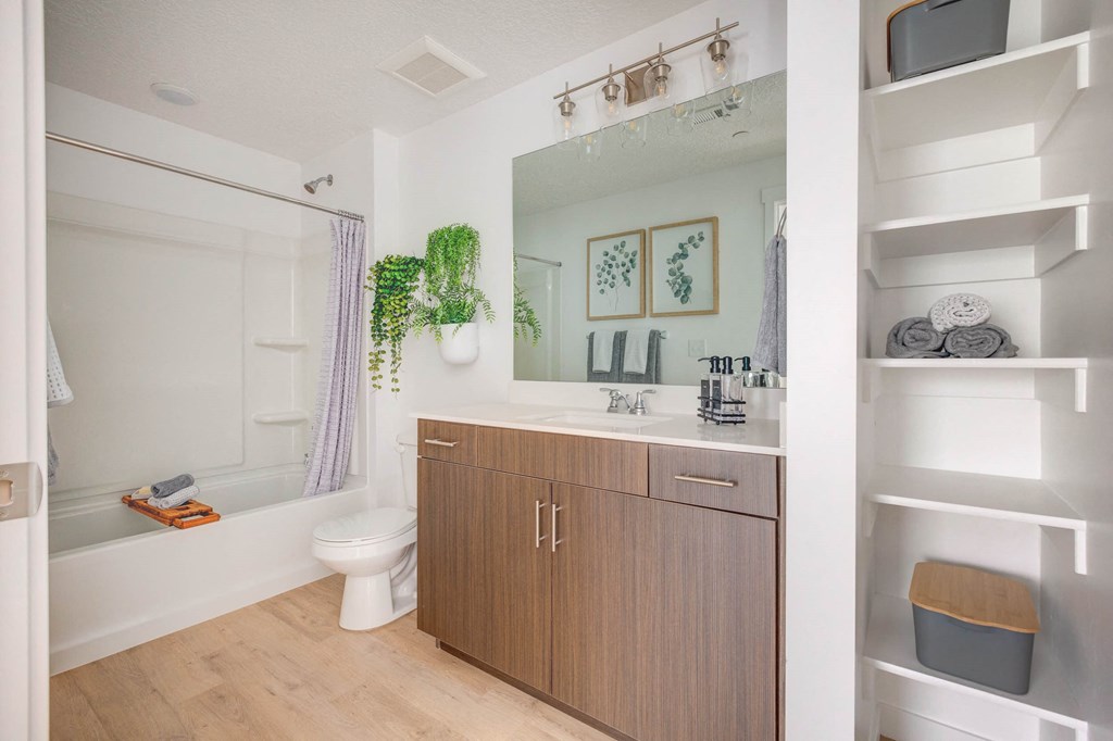 a bathroom with a toilet sink and a mirror