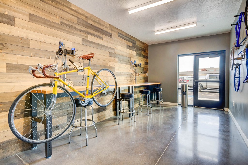 a bike hanging on a wall in a room with a bar