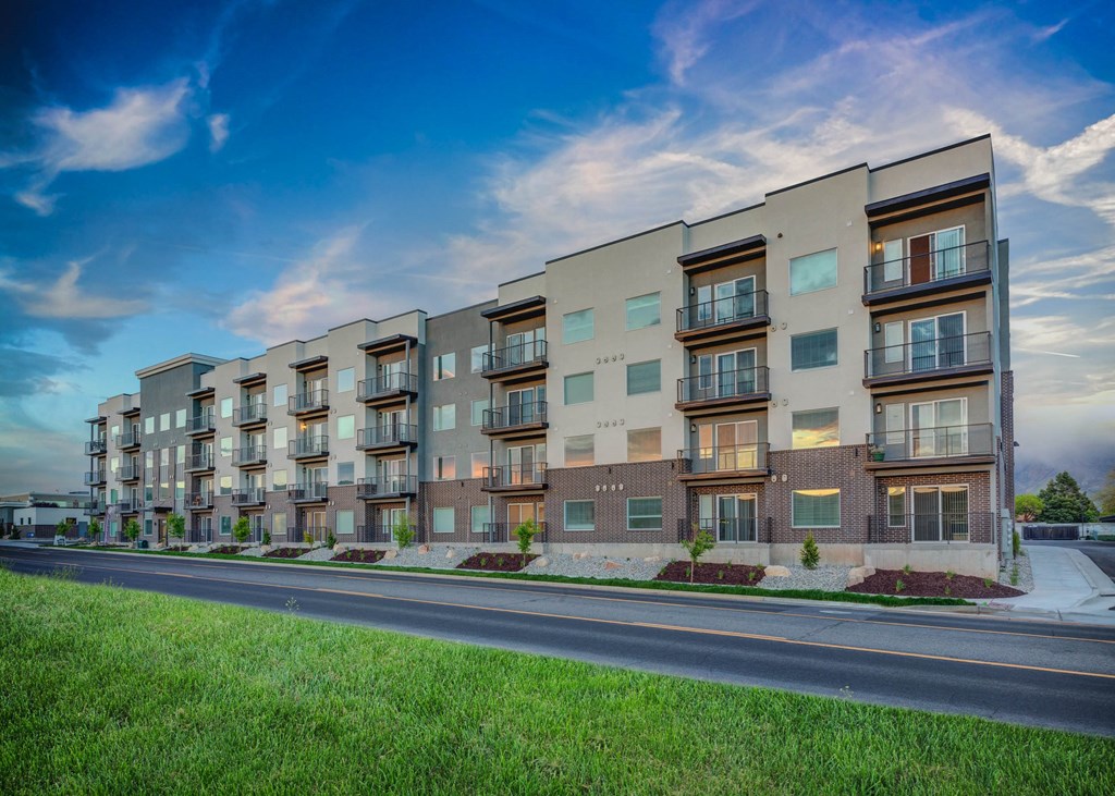 a rendering of an apartment building on the side of a street