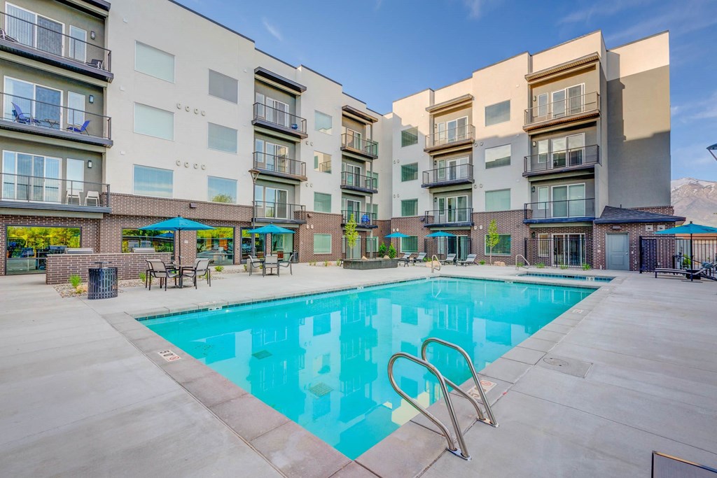 a swimming pool in front of an apartment building