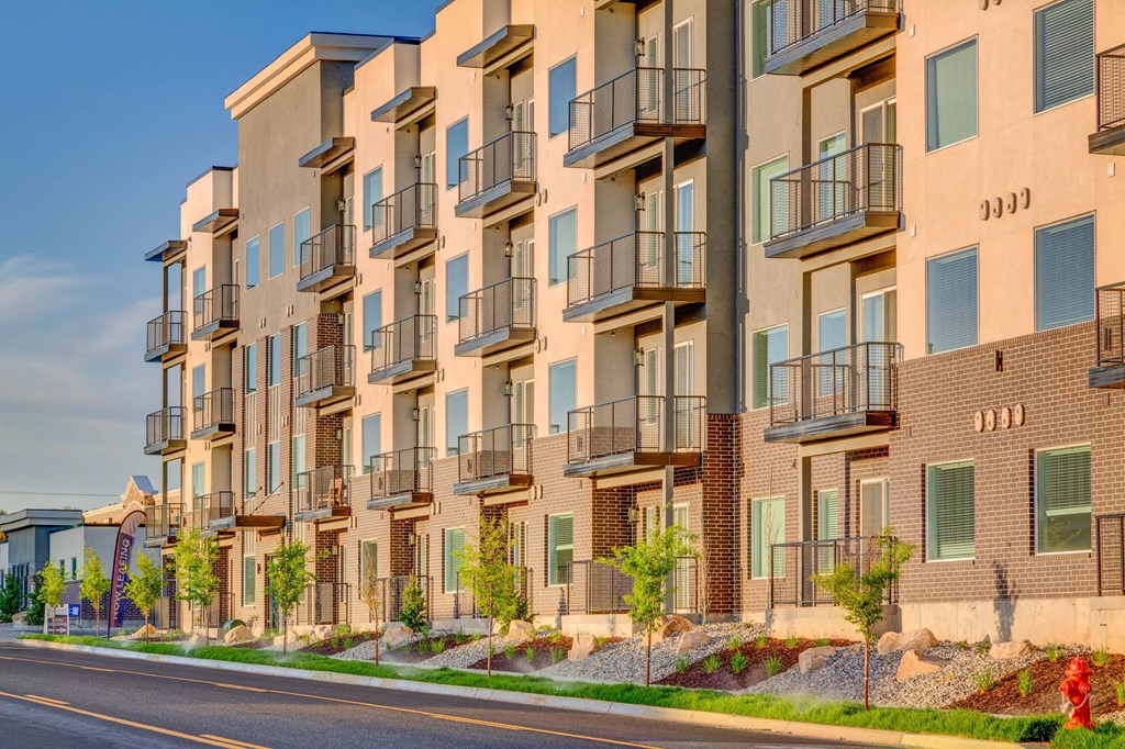 an empty street in front of an apartment building