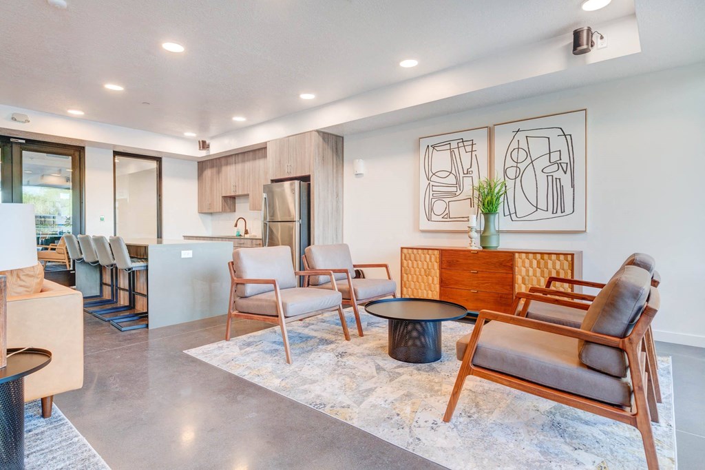 a living room with chairs and a table
