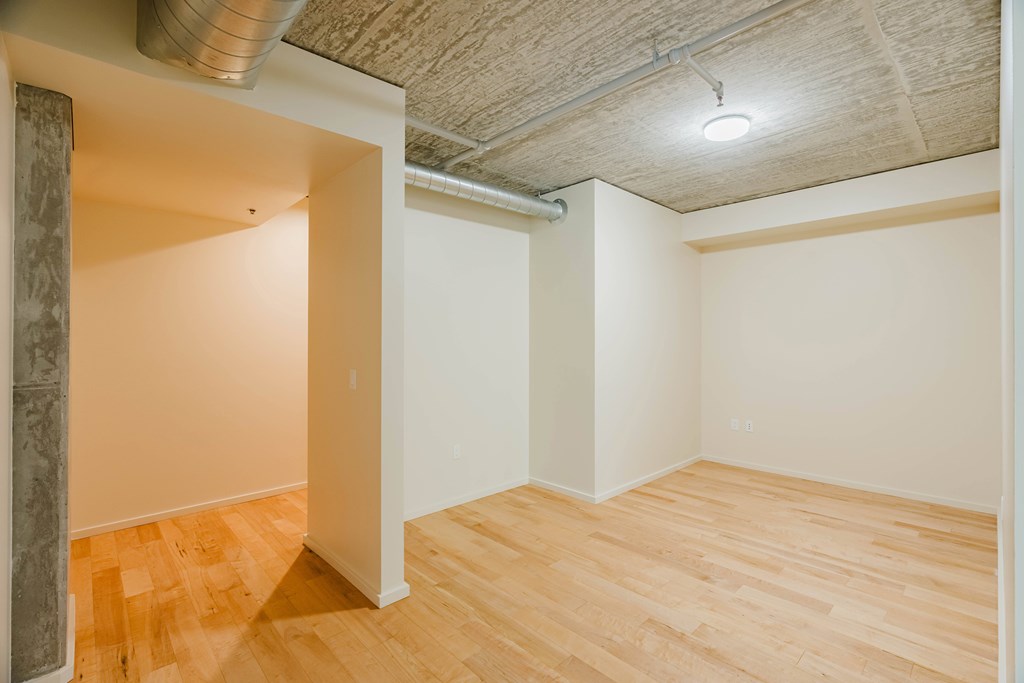A room with wooden floors and a ceiling with a light fixture.