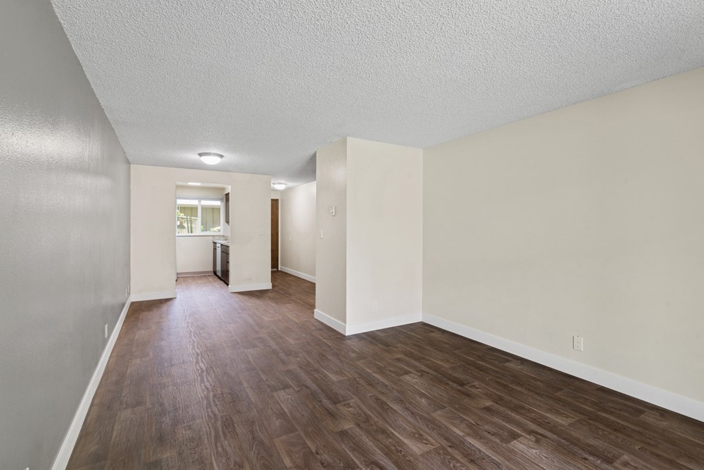 A room with wooden floors and white walls.