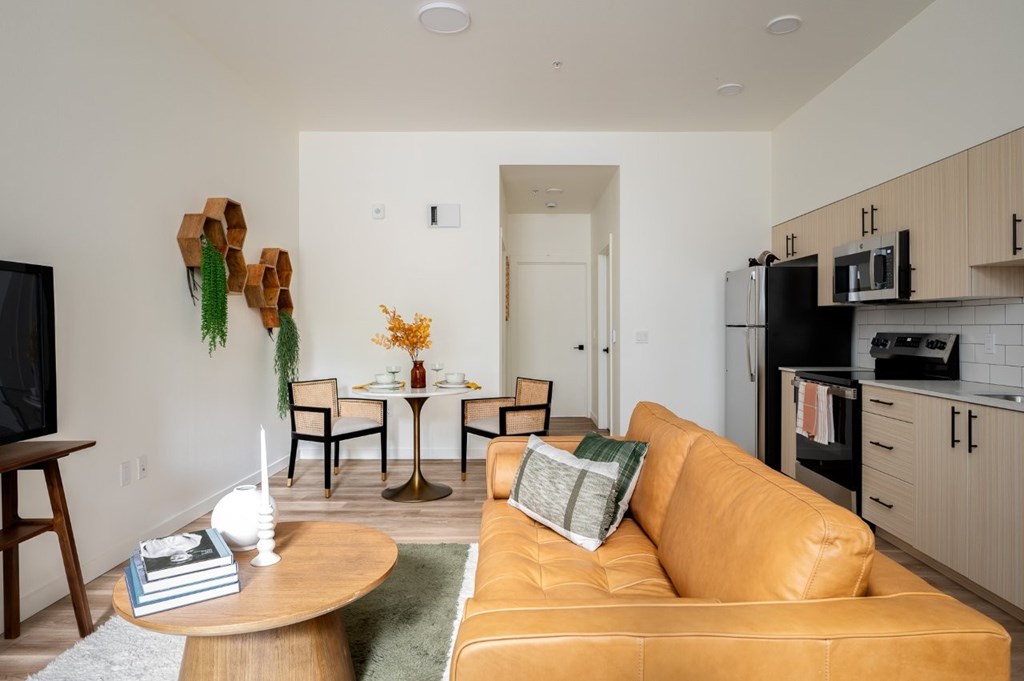 The Wes Gresham Oregon Apartments A living room with a brown couch and a wooden coffee table.