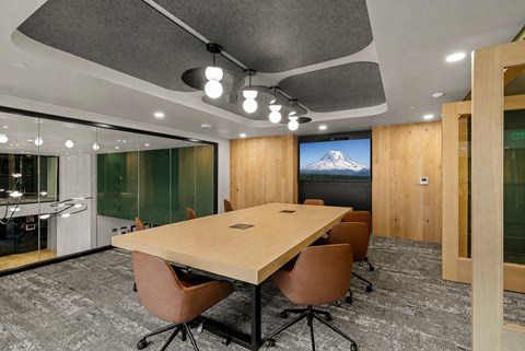 A conference room with a large table and chairs.