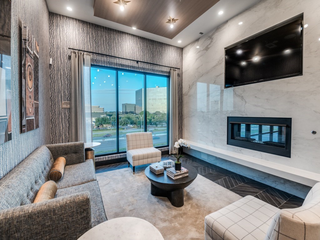A modern living room with a large window overlooking the city.