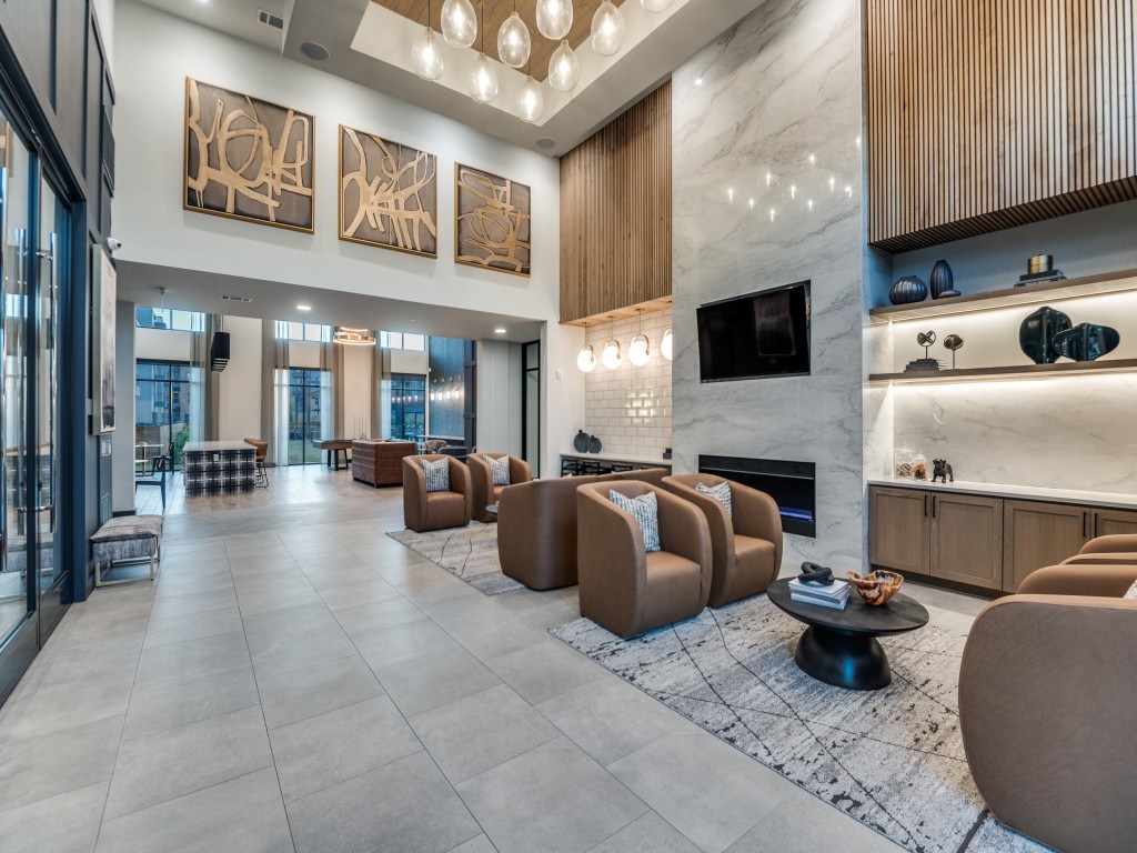 A modern living room with a fireplace and a large painting on the wall.