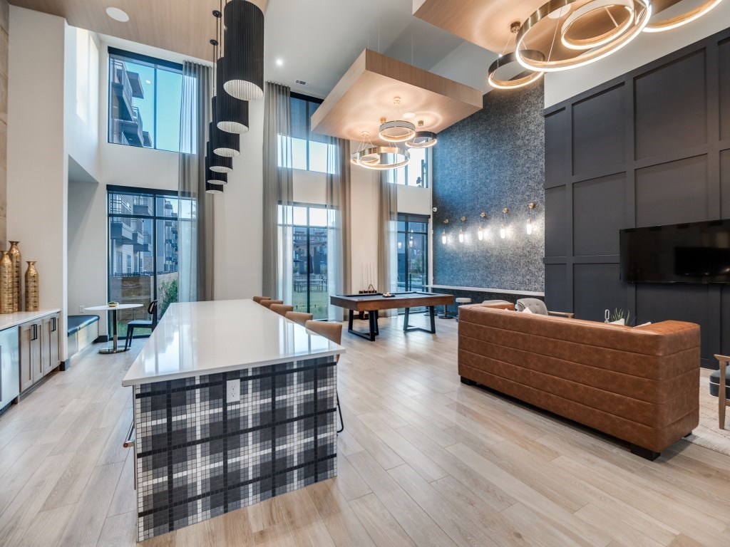 A modern kitchen with a checkered table and a wooden bench.