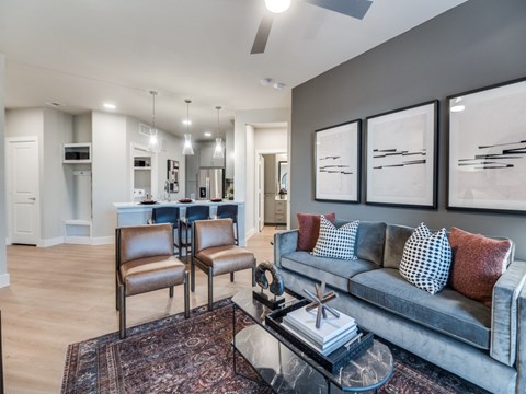 A living room with a grey couch and a coffee table.