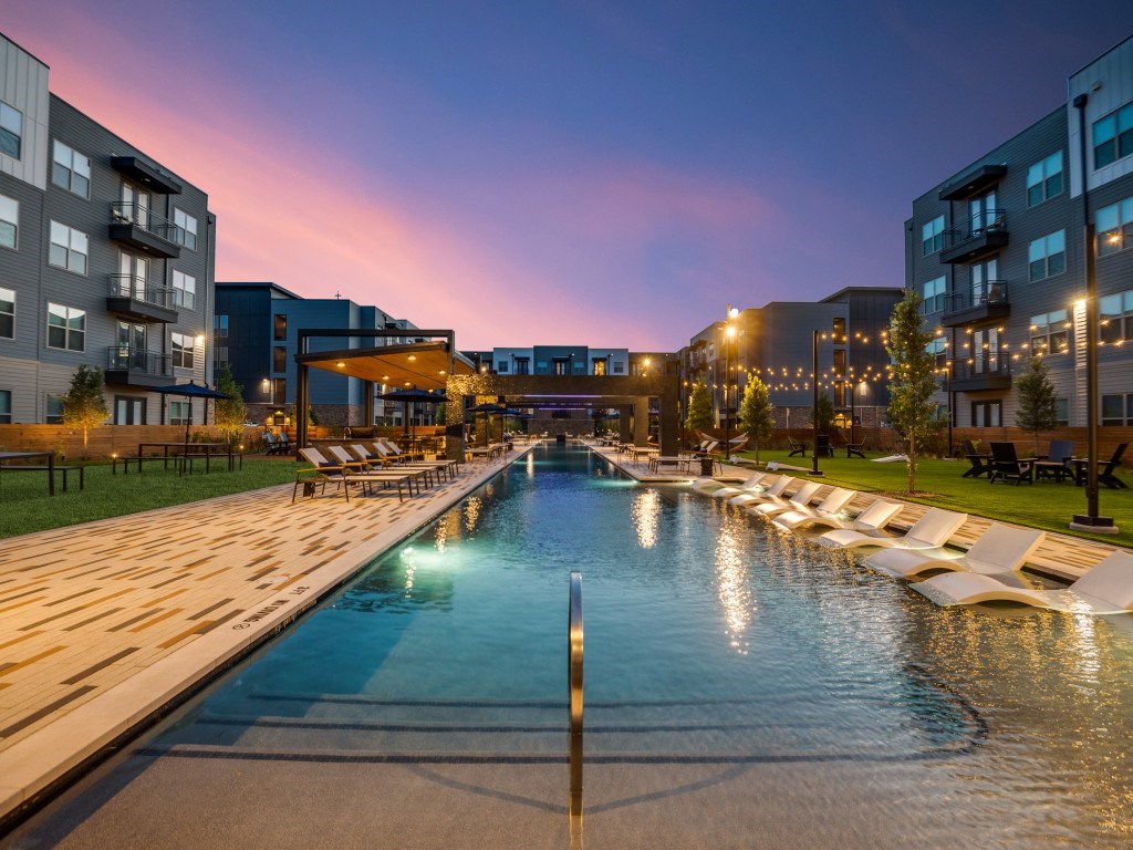 A long rectangular pool with a metal pole in the middle of it.