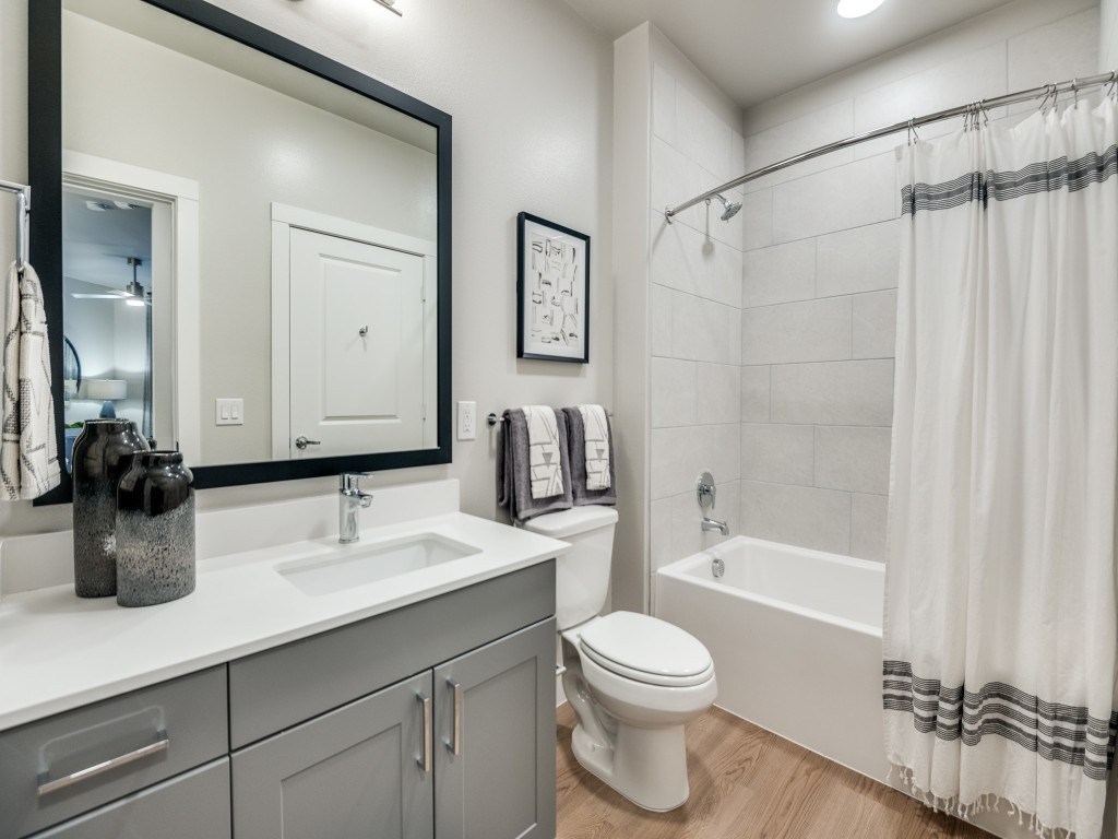 A bathroom with a white toilet, sink, and bathtub.