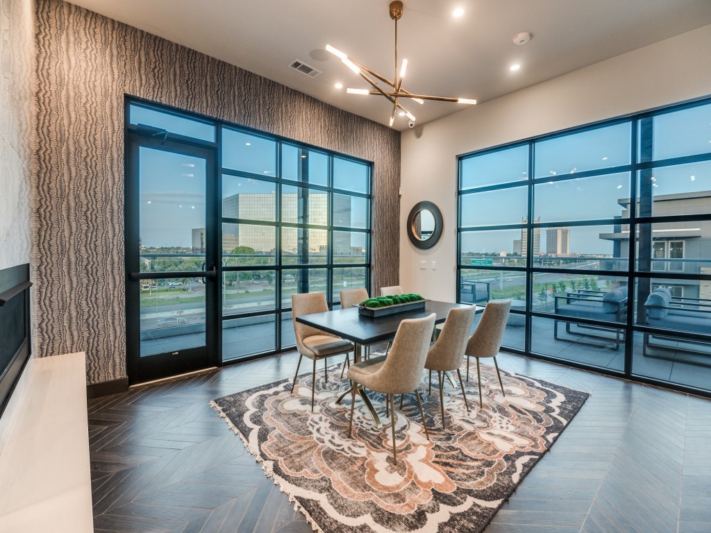 A dining room with a table set for four and a view of the city.