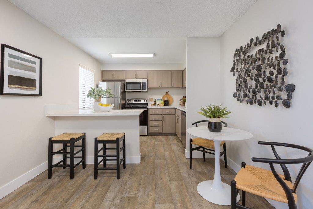 an open kitchen and living room with a table and chairs