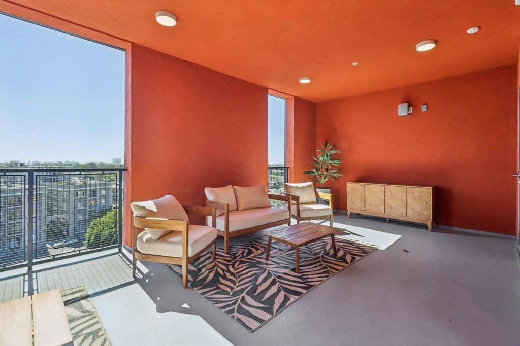 A living room with orange walls and furniture.