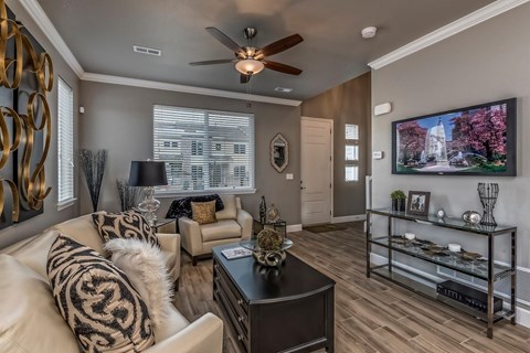 A living room with a white couch and a black coffee table.