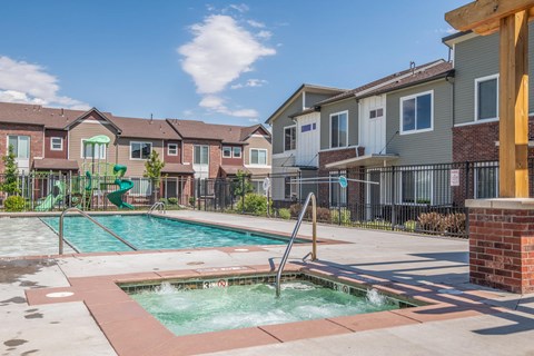 A small pool with a slide in a residential area.