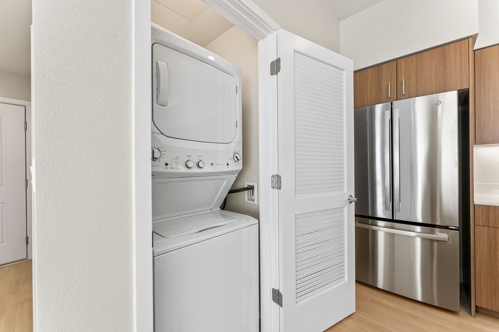a kitchen with a washer and dryer and a refrigerator