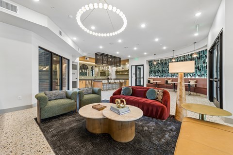 A modern living room with a red couch and a coffee table.