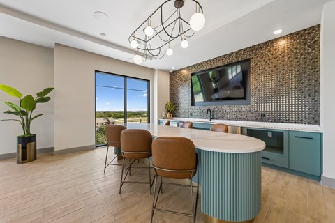 A modern kitchen with a dining table and chairs.