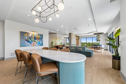 A modern dining room with a large table and chairs.