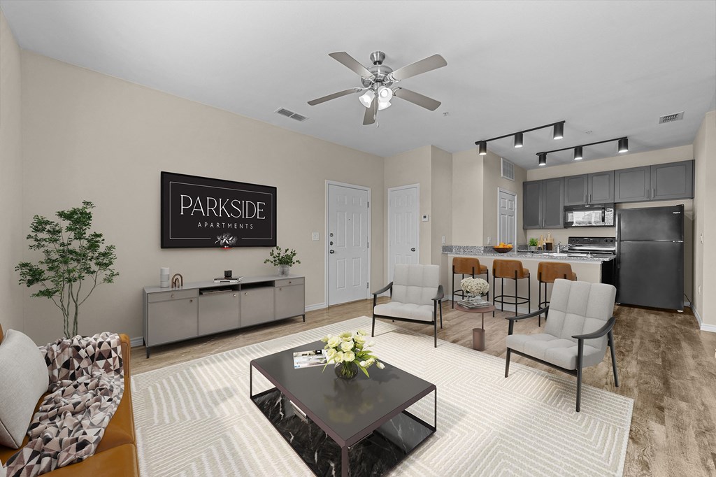 A living room with a Parkside Apartments sign on the wall.