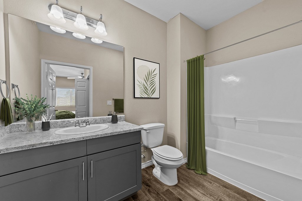 A bathroom with a toilet, sink, and bathtub.