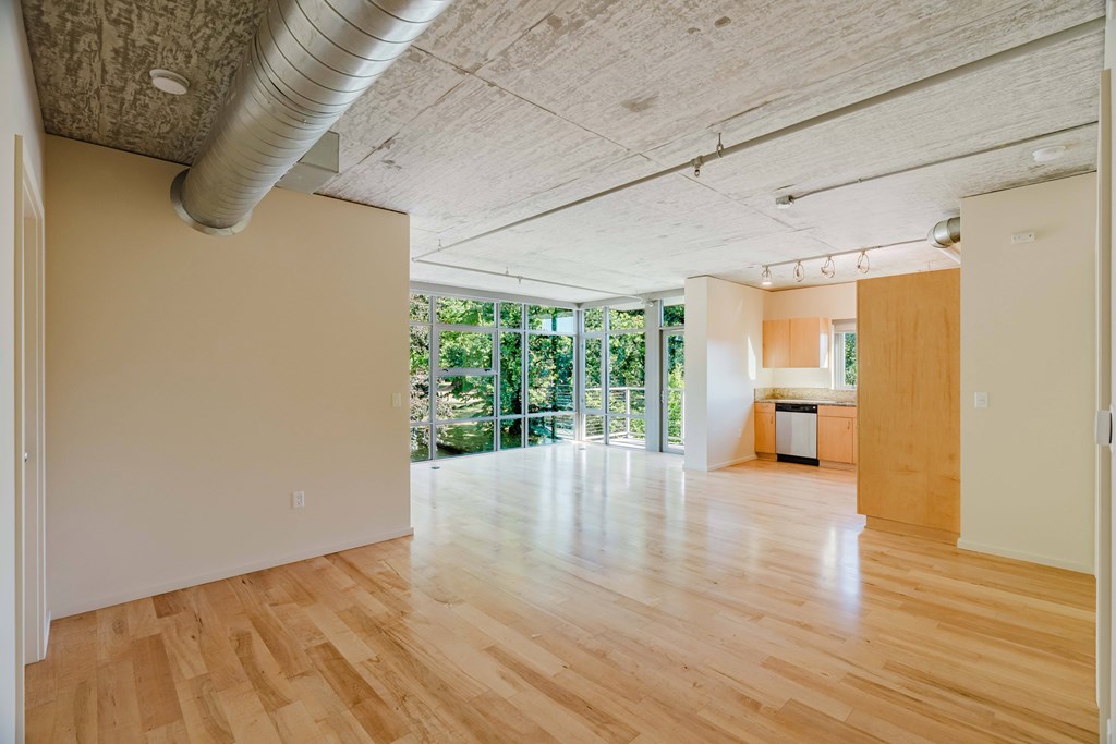 A room with wooden floors and a large window.
