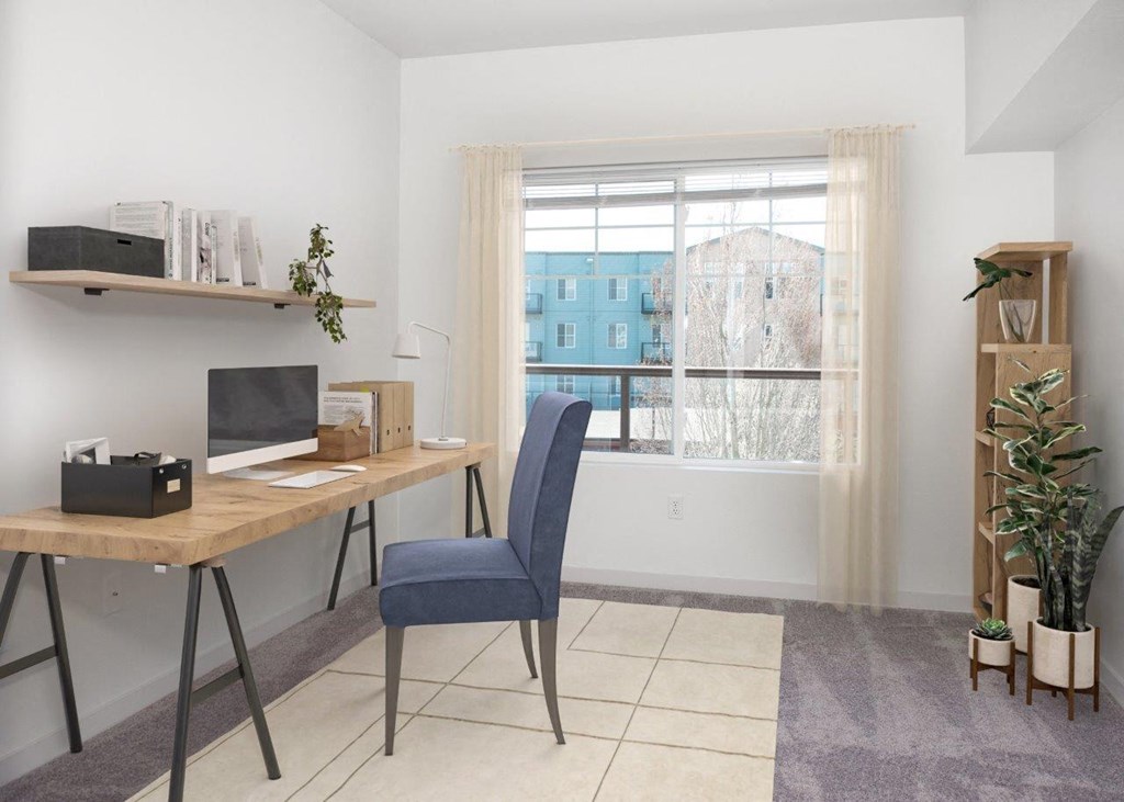 a home office with a desk and a window