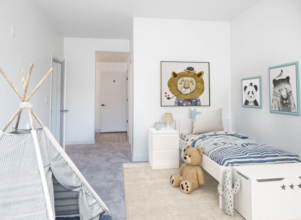 a bedroom with a bed and a teddy bear