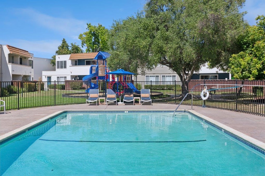 A swimming pool with lounge seating