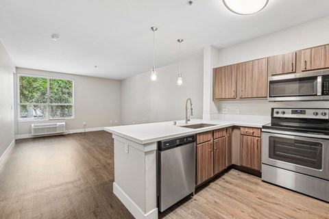 A kitchen with wooden cabinets and stainless steel appliances.